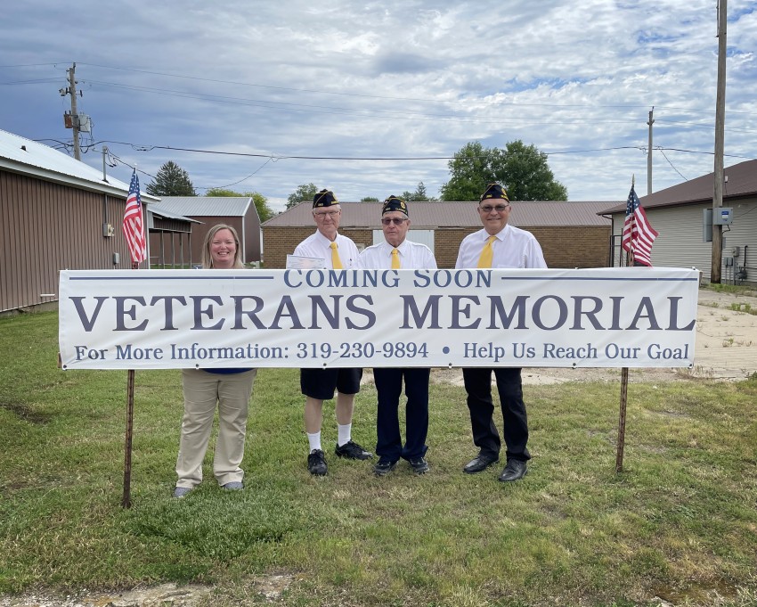 First Security Lead Retail Advisor Katie Menken and Dumont American Legion Members Jack D. Ritsema, Otto Tjaden, and Al Buseman in front of location for memorial.