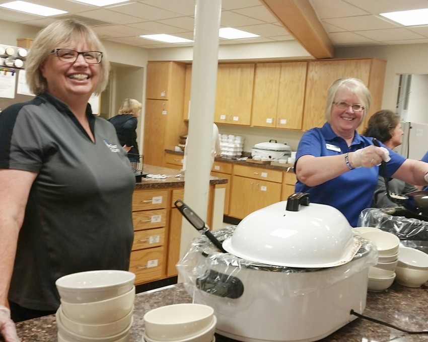 Donnis and her long-time coworker and friend Michelle Schaefer volunteering at a community meal.