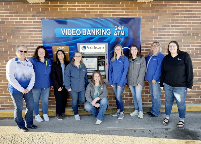 Hampton bank staff standing in front of ITM.