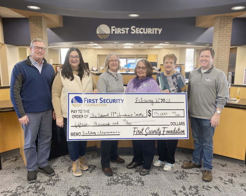 Photo of First Security staff presenting a check to NNAS board members.