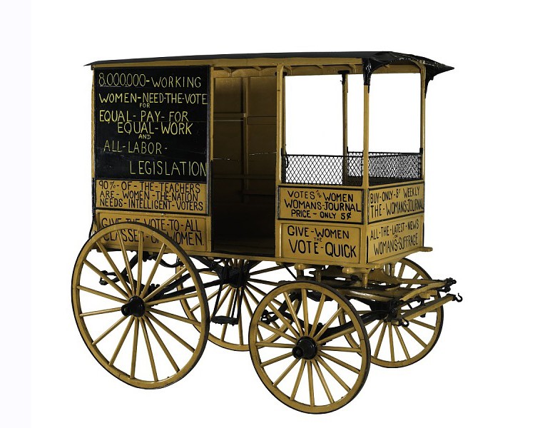 A photo of one side of the original suffrage wagon.