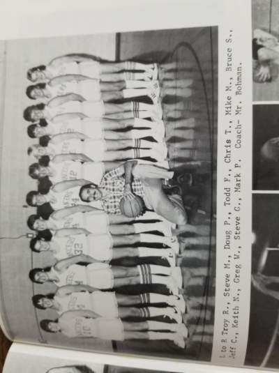 Randy posing with the basketball team in the school's yearbook.